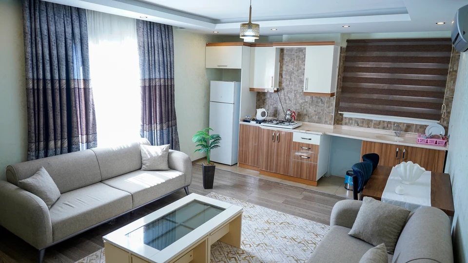 Daire 17 — salon ve ahşap dolaplı açık mutfak